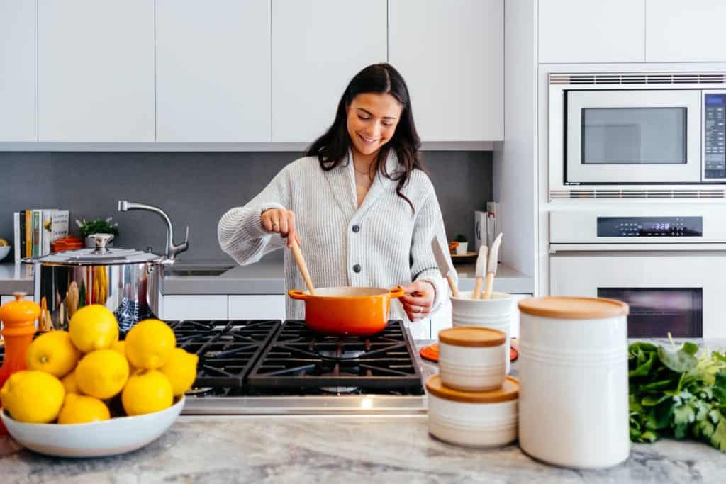 woman cooking inside kitchen room. Easy weeknight dinner