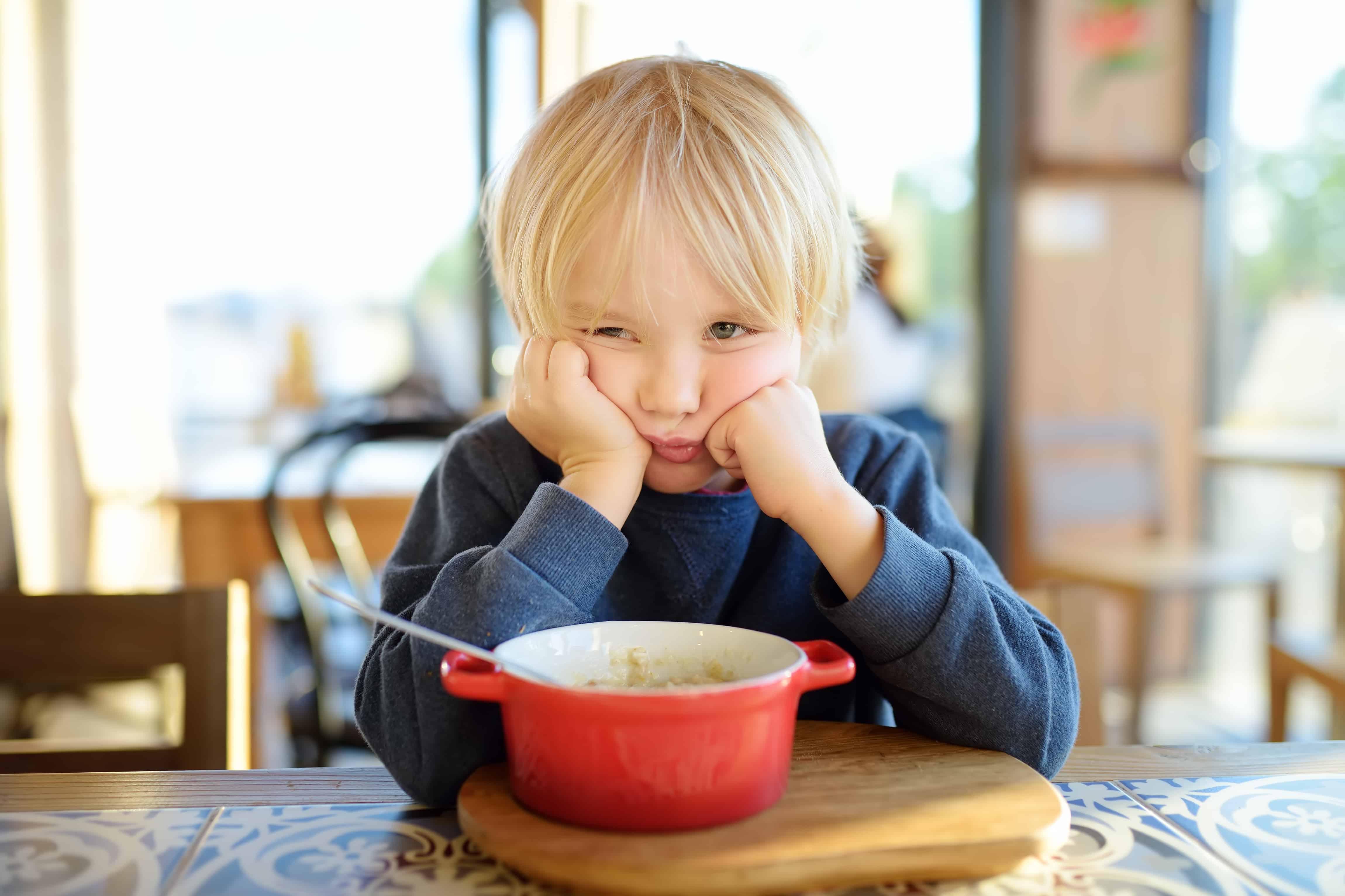 A little kid not happy about the food in front of him.  Let's get a fussy eater list.