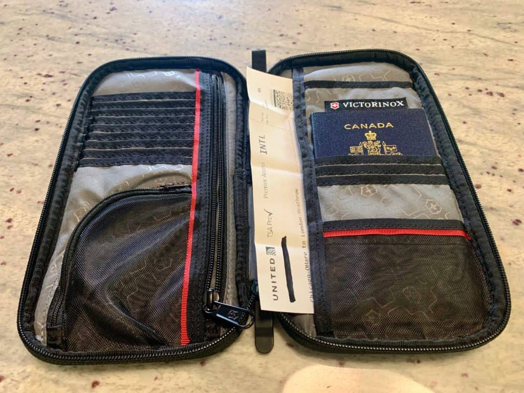 Black document carrier showing a Canadian passport and a boarding pass