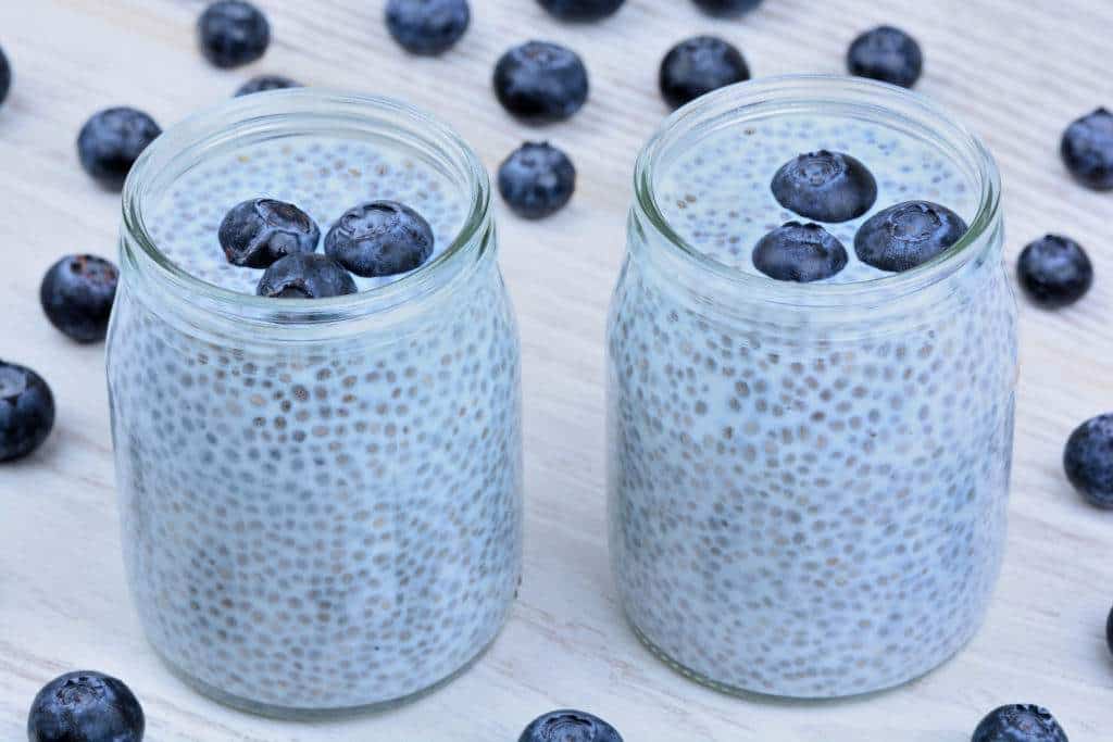 Snack ideas for work - Chia seeds pudding with blueberries in a glass jar on table