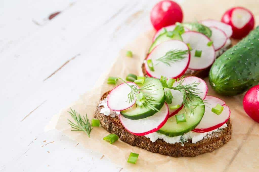 Open face sandwiches with radishes, cucumbers and dill