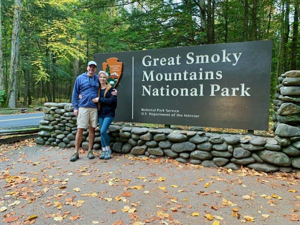 A couple by a Smokey Mountains National park sign