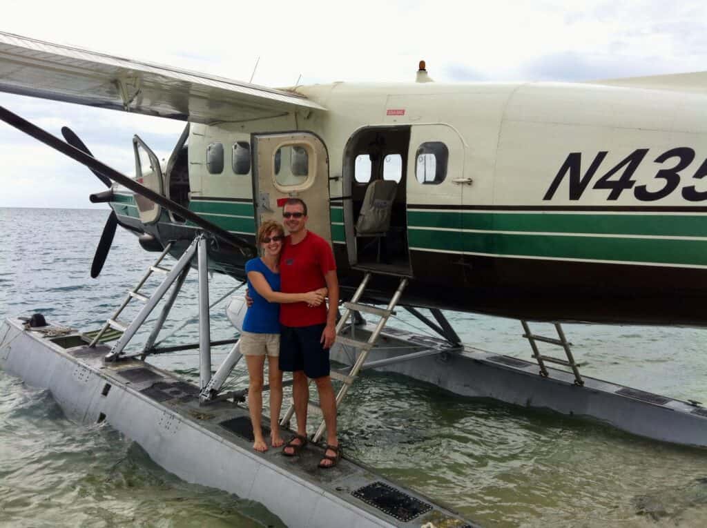 A couple in front of a sea plane during a Florida keys trip