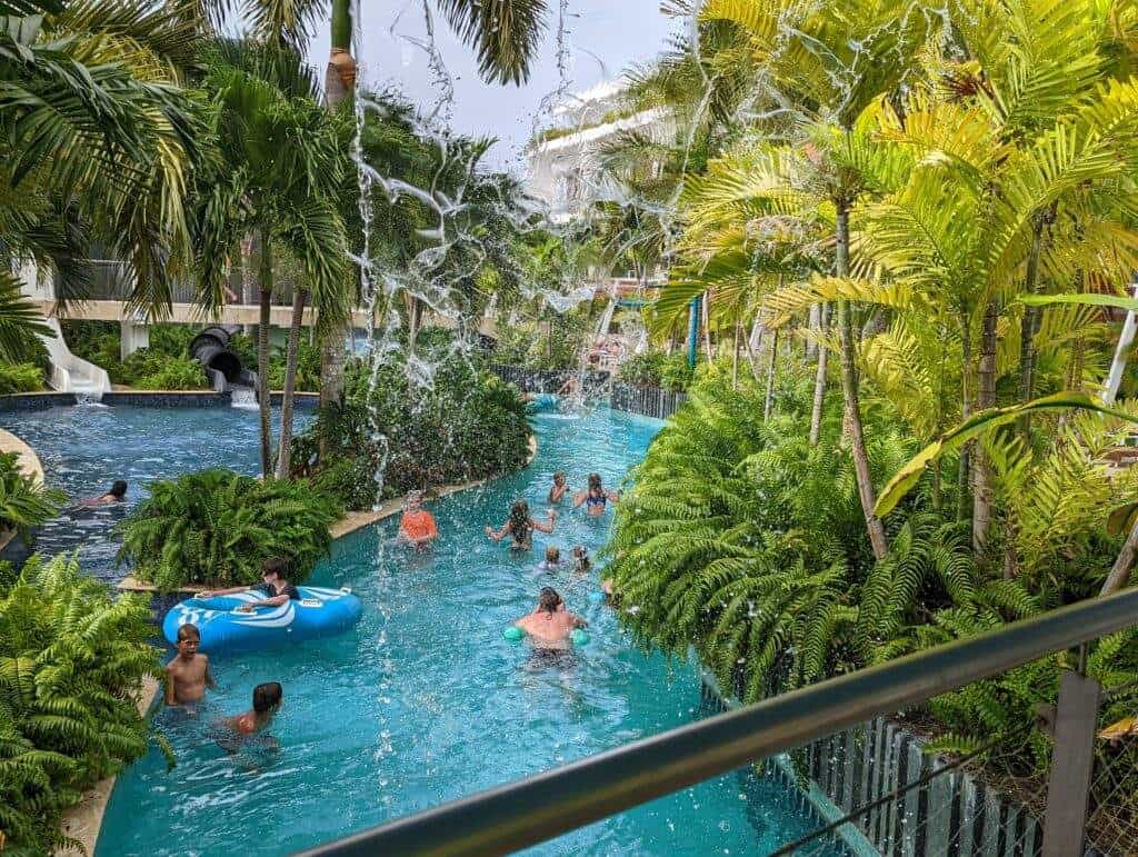 View of a water park including water slides, tubes, lots of people and many tropical plants in Punta Cana.