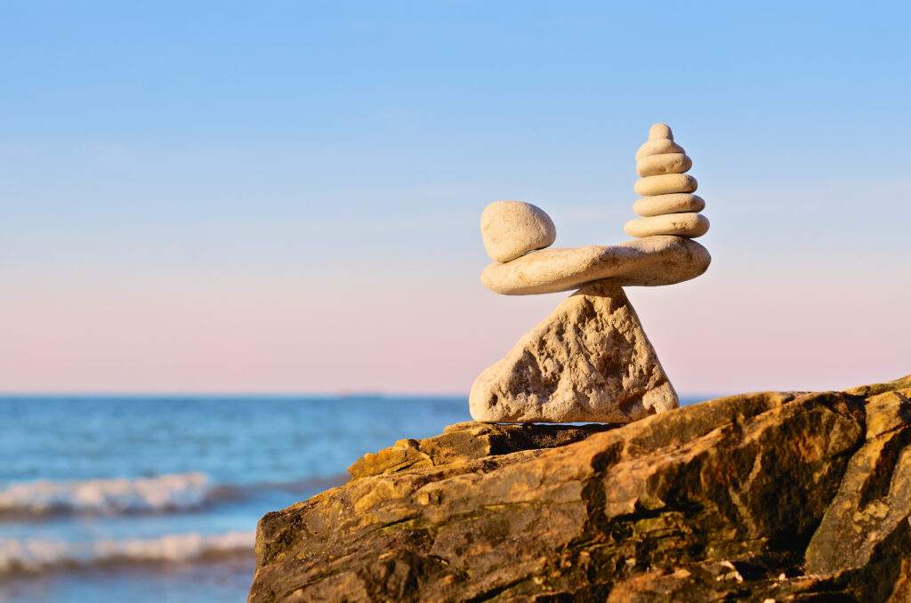 Rock finding balance in life in front of an ocean