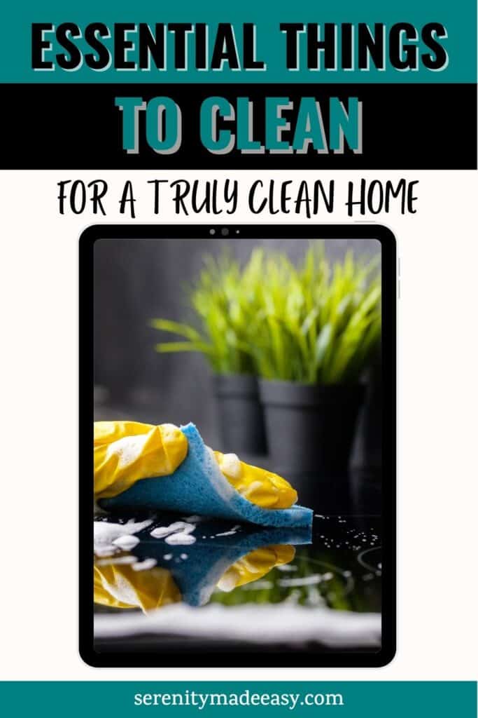 Essential things to clean for a truly clean home with someone with yellow gloves cleaning a stove with a blue sponge.
