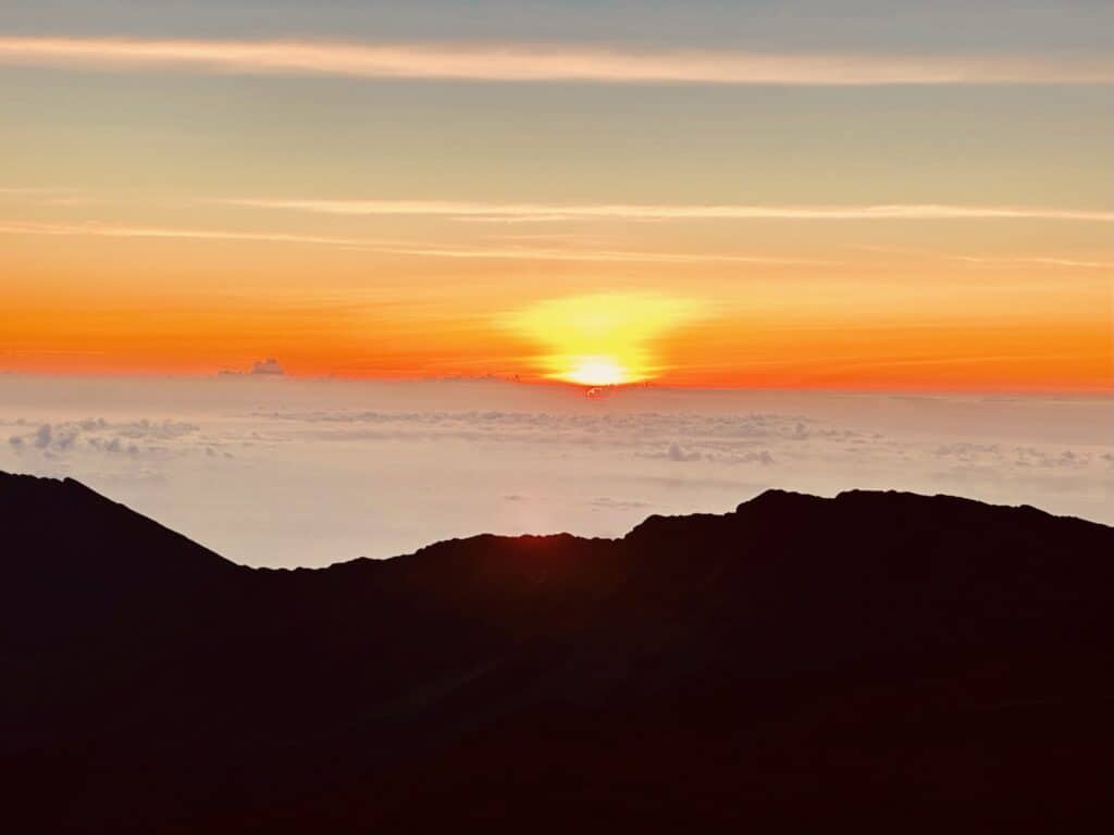 View of the sunrise over Haleakala during a National Park vacation.