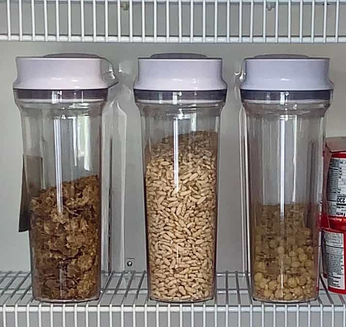 3 larges OXO containers with cereals in them in a wire shelf pantry organization