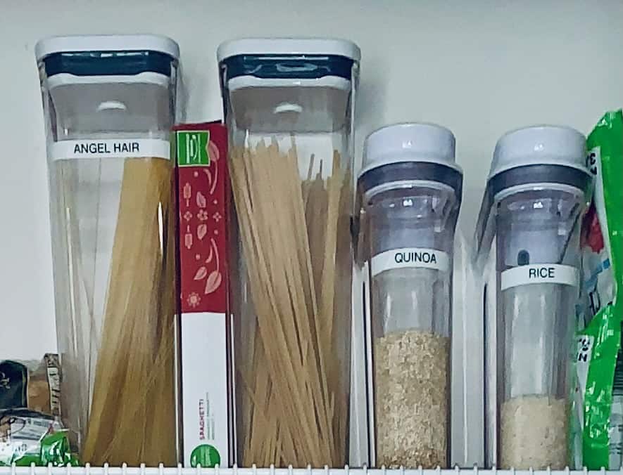 2 large pasta OXO containers and 2 smaller ones with pasta and rice in them. Wire shelf pantry organization at its finest.