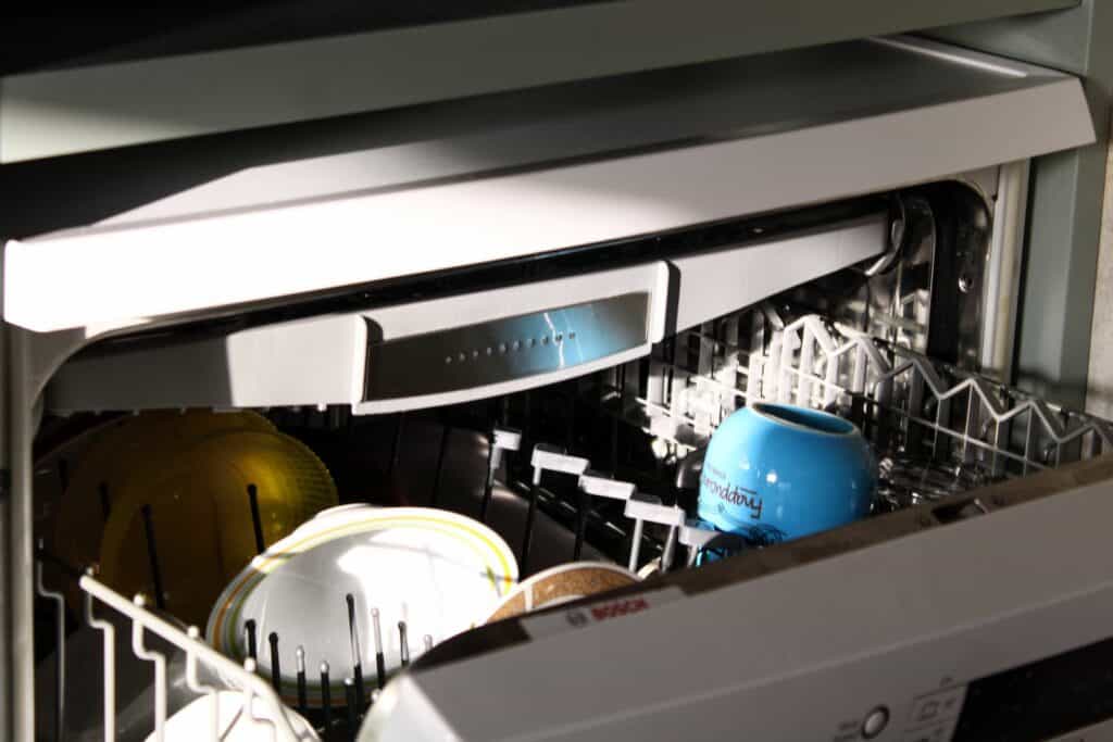 blue and white cooking pot in a dishwasher. Add to the checklist before going on vacation.