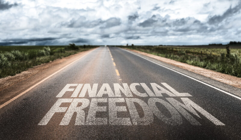 A photo of a road with words saying Financial Freedom