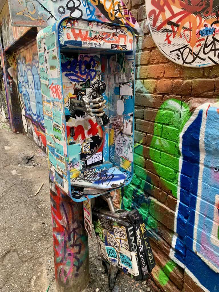 An old phone booth turned artwork in Graffiti alley