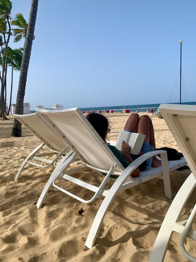 A boy reading on vacation. Nothing better than a holiday reads on a beach.