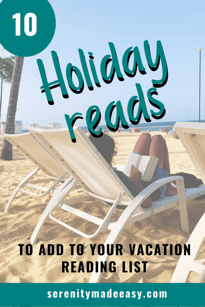 A boy reading a book on vacation on a beach.