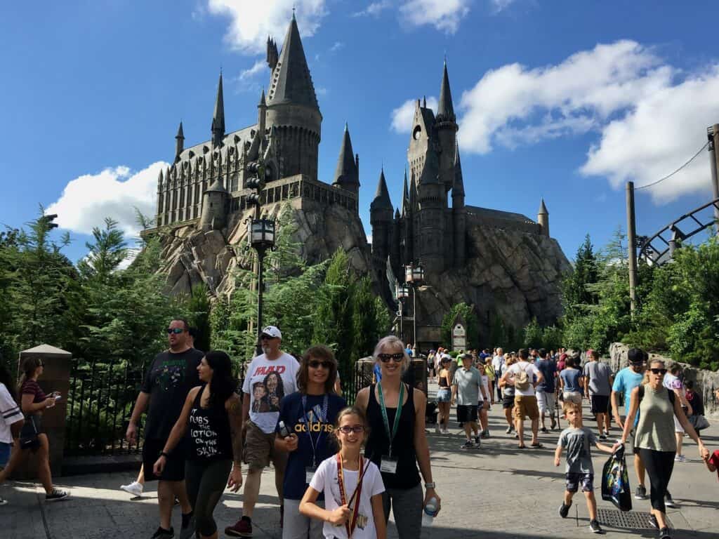 Several people standing in front of the Hogwarts Castle at Universal in Orlando Florida.