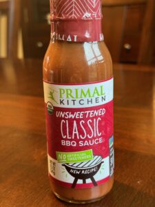 A bottle of Primal Kitchen unsweetened BBQ sauce