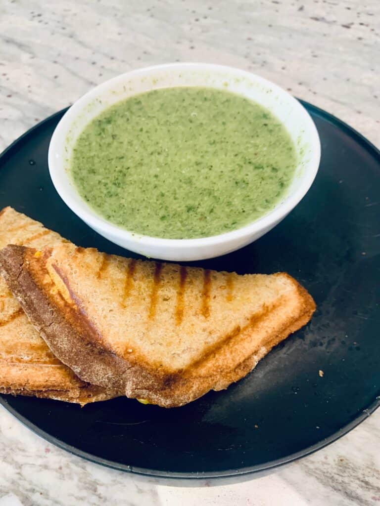 A bowl of asparagus soup and a grilled cheese sandwich for a simple Spring meal