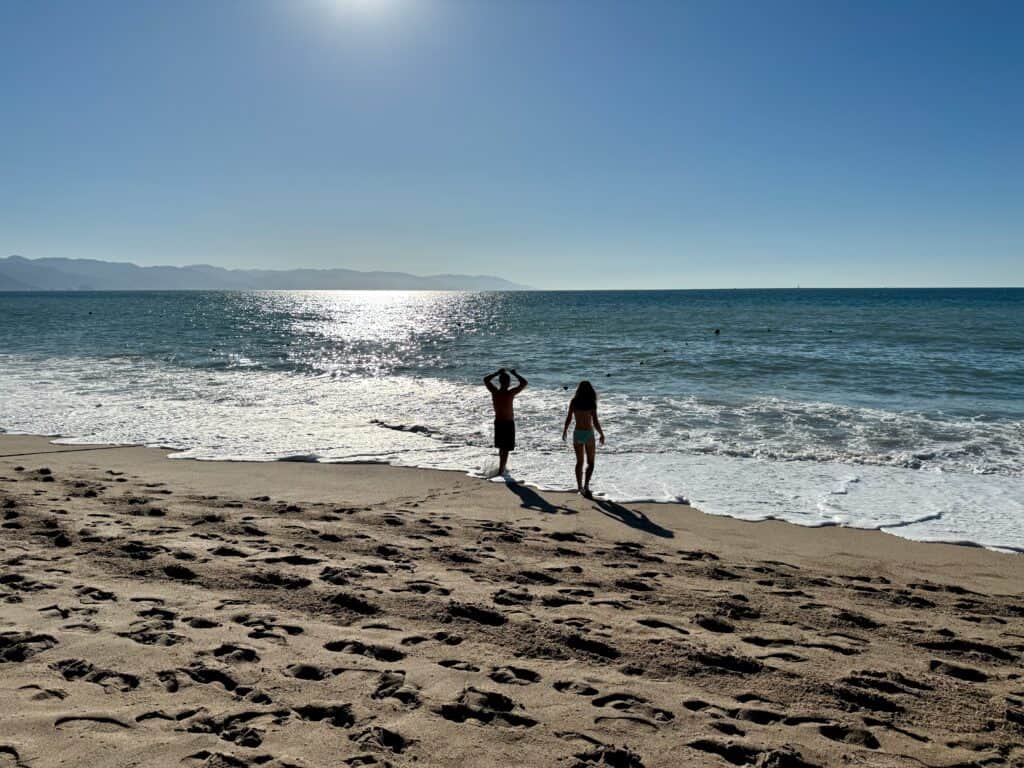 Beautiful beach with two people standing on the sand