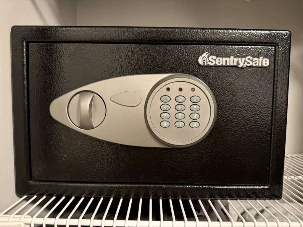 Photo of a personal home safe on a wire shelf. Perfect for student, dorm safety. Graduation gift.