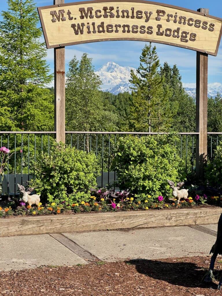 Mount Denali under a sign of the McKinley Princess Lodge in Alaska.